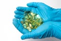 A handful of yellow omega-3 capsules.