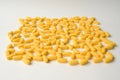 Pharmacy concept of handful of yellow tablets lying on a white surface