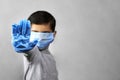 Handgesturing stop - 7 years old boy in medical face mask and gloves