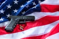 A handgun and bullets on American flag background. Royalty Free Stock Photo