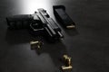 Handgun, magazine and bullets on grey table Royalty Free Stock Photo