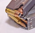 A handgun magazine loaded with .40 caliber hollow point bullets on top of a rifle magazine loaded with .223 caliber bullets Royalty Free Stock Photo