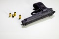 Handgun with 9mm shell casings on white table Royalty Free Stock Photo