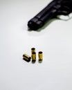 Handgun with 9mm shell casings on white table Royalty Free Stock Photo