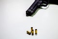 Handgun with 9mm shell casings on white table Royalty Free Stock Photo