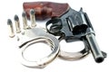 Handgun revolver and police handcuff with bullets