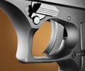 Handgun trigger closeup with an orange background