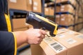 handheld barcode reader scanning a product box