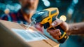 Handheld barcode scanner reading a shipping label on a cardboard package inside a busy warehouse Royalty Free Stock Photo