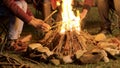 Handheld footage of man making camp fire for his friends in a cold night