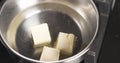 Handheld shot of adding butter into water