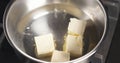 Handheld shot of adding butter into water