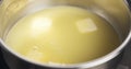 Handheld shot of butter melting in water Royalty Free Stock Photo