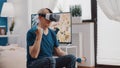 Handheld shot of elder man training with dumbbells and using vr glasses Royalty Free Stock Photo