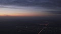 Handheld shot flying on airplane over night citys grainy