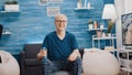 Handheld shot of senior man smiling and holding dumbbell Royalty Free Stock Photo