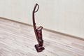 Upright red vacuum cleaner in empty room