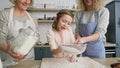 Video of little girl helps to sift the flour.