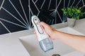 Handheld Water Flosser for Oral Hygiene Improvement in a Modern Bathroom Setting with Sleek Design and Functional Features Royalty Free Stock Photo