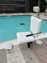 Handicap chair for accessibility to a swimming pool