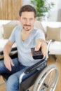 handicap man using remote control while watching television Royalty Free Stock Photo