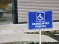Handicap Parking Sign In Front Of A Building.