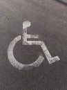 A handicap sign painted on the ground in a parking lot Royalty Free Stock Photo