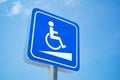 Handicap sign. White symbol over blue background on blue sky background Royalty Free Stock Photo