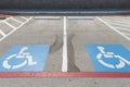 Handicap symbols on asphalt road, parking place reserved for disabled person or people Royalty Free Stock Photo