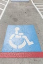 Handicap symbols on road and wall, parking place reserved for disabled person Royalty Free Stock Photo