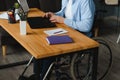 Handicapped Businessman Sitting On Wheelchair And Using Computer In Office. Royalty Free Stock Photo