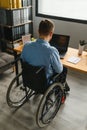 Handicapped Businessman Sitting On Wheelchair And Using Computer In Office Royalty Free Stock Photo