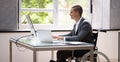 Handicapped Businessman Using Laptop Computer