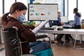 Handicapped businesswoman wearing medical protection face mask against coronavirus