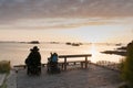 Handicapped couple in wheelchairs enjoy a beautiful ocean sunset together from a handicapped beach access viewpoint