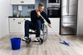 Handicapped Disabled Man Cleaning Kitchen Floor