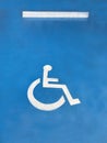 Handicapped or disabled parking sign on blue concrete parking lo Royalty Free Stock Photo