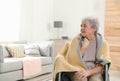 Handicapped elderly woman covered with blanket at nursing home. Assisting senior people