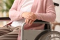 Handicapped elderly woman in nursing home. Assisting senior generation