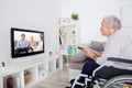 Handicapped Grandmother Watching Movie On Television Royalty Free Stock Photo