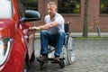 Handicapped man opening door of a car Royalty Free Stock Photo