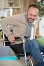 handicapped man trying to sit on sofa Royalty Free Stock Photo