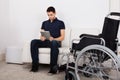 Handicapped Man Using Digital Tablet On Sofa Royalty Free Stock Photo