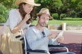 Handicapped man in wheelchair and girlfriend on holidays Royalty Free Stock Photo