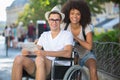 handicapped man in wheelchair and girlfriend on holidays Royalty Free Stock Photo