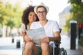 handicapped man in wheelchair and girlfriend on holidays Royalty Free Stock Photo
