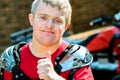 Handicapped motocross rider doing thumbs up. Royalty Free Stock Photo