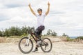 Handicapped mountain bike raising up arms Royalty Free Stock Photo