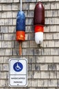 Handicapped Parking sign in Maine with lobster buoys on wall Royalty Free Stock Photo
