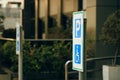 Handicapped parking sign near Electric blue Building